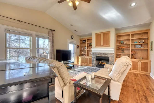 a living room with furniture a fireplace and a flat screen tv