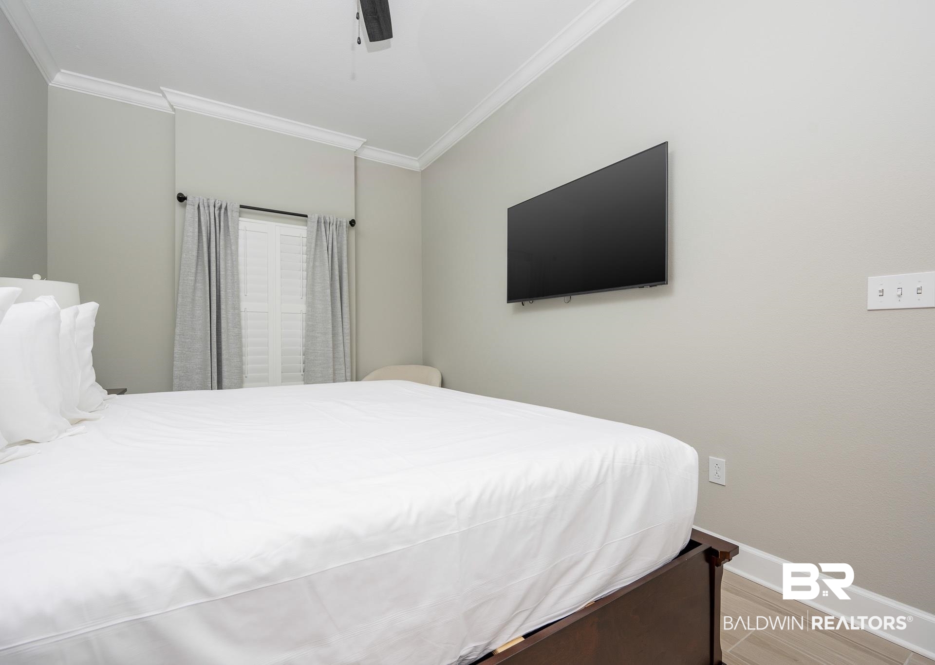 23008 Perdido Beach Boulevard, Unit 506 Orange Beach, AL 36561 - Photo 13 of 48 Bedroom with baseboards, ornamental molding, light wood-style flooring, and ceiling fan