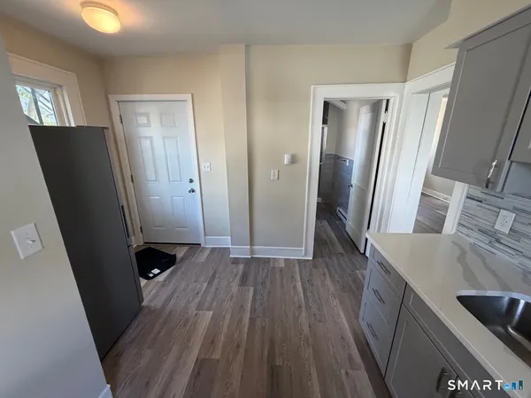 a view of a kitchen from a hallway
