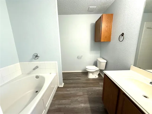 a bathroom with a sink a toilet and a bathtub