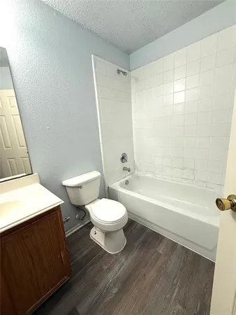 a bathroom with a toilet a sink and bathtub