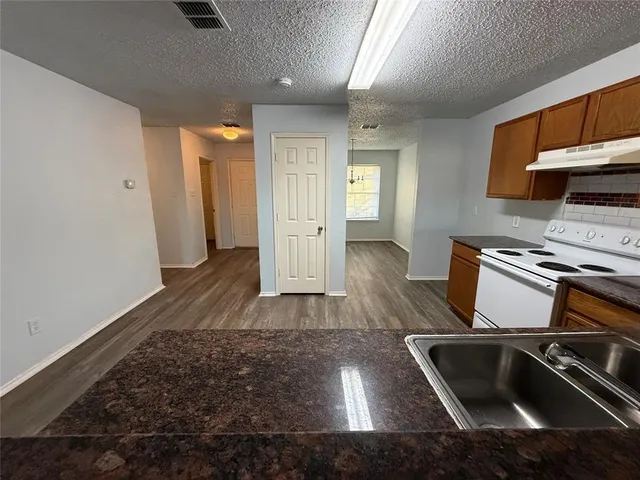 a kitchen with a sink and a stove top oven