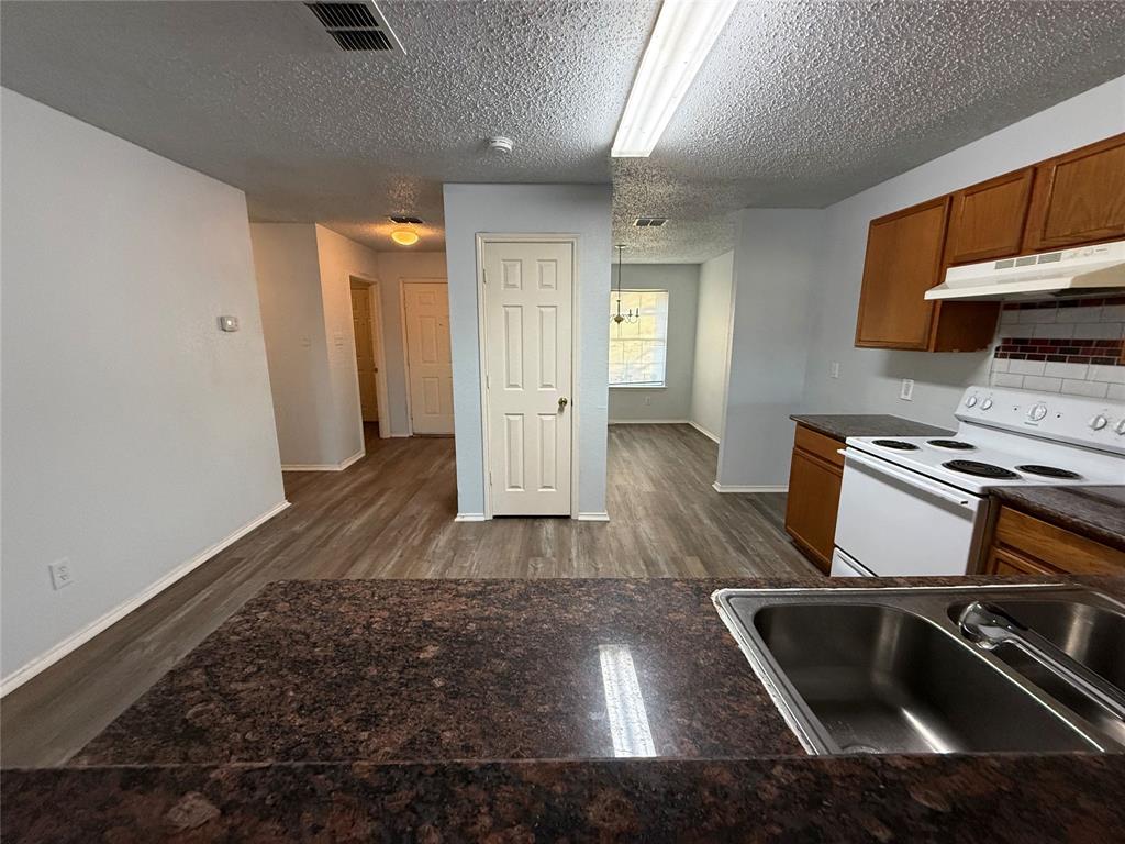 1710 White Oak Road Anna, TX 75409 - Photo 3 of 14 a kitchen with a sink and a stove top oven