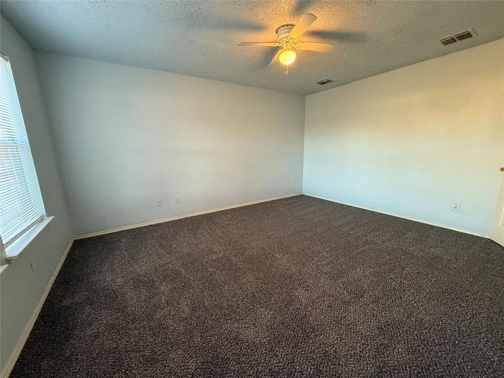 1710 White Oak Road Anna, TX 75409 - Photo 10 of 14 an empty room with a window and a fan