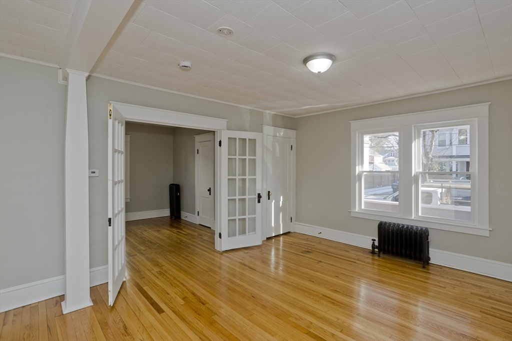 34-36 Ruskin Street Springfield, MA 01108 - Photo 11 of 27 a view of empty room with wooden floor and fan