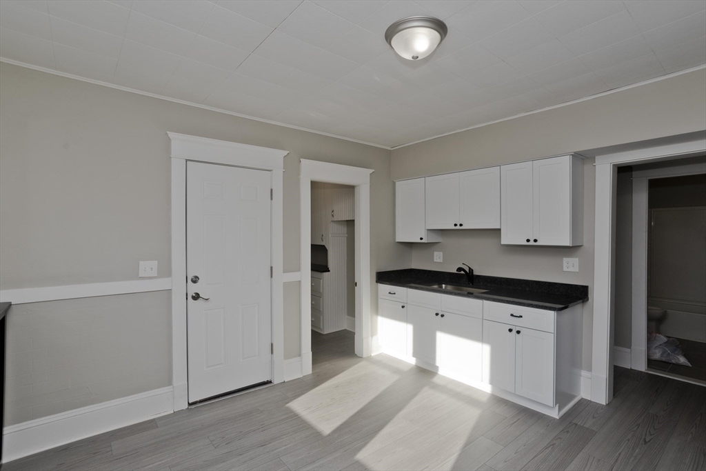 34-36 Ruskin Street Springfield, MA 01108 - Photo 14 of 27 a kitchen with granite countertop a stove a sink and a refrigerator