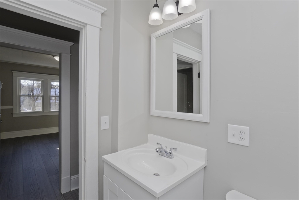 34-36 Ruskin Street Springfield, MA 01108 - Photo 15 of 27 a bathroom with a sink a mirror and a toilet