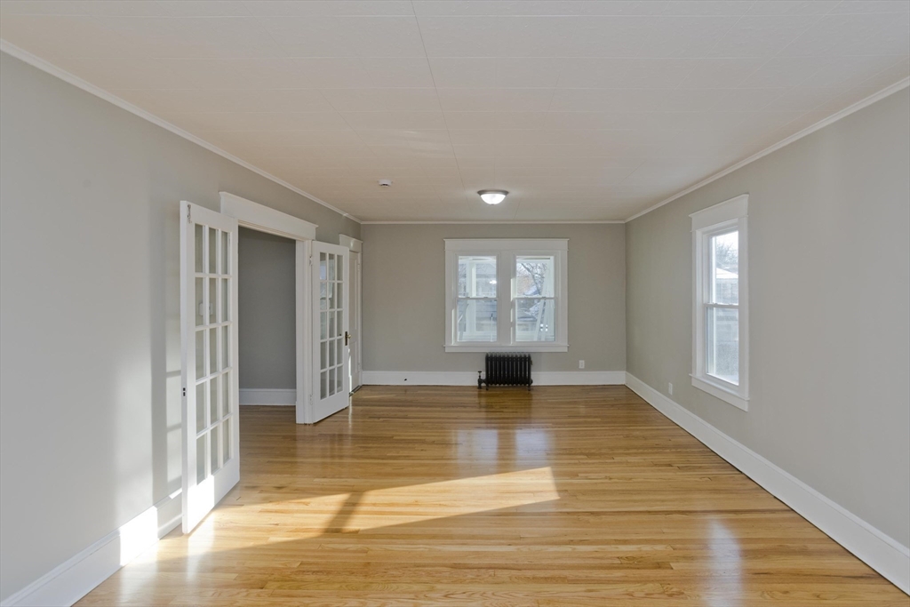 34-36 Ruskin Street Springfield, MA 01108 - Photo 17 of 27 a view of an empty room with window and wooden floor