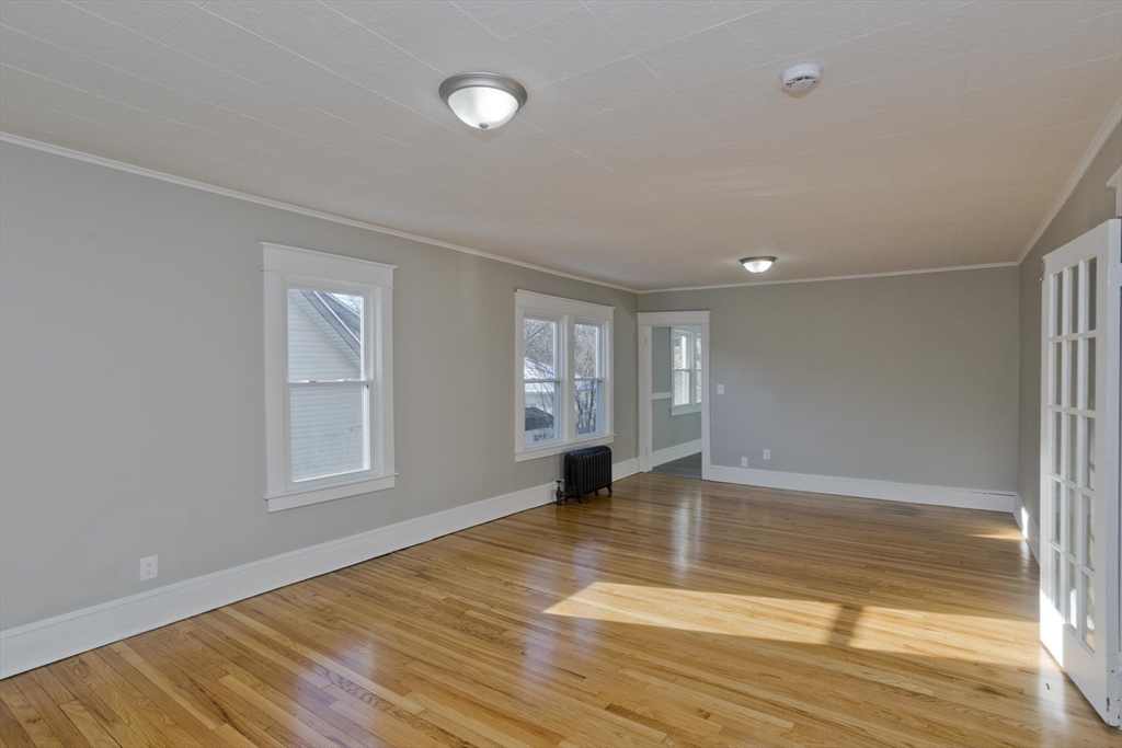 34-36 Ruskin Street Springfield, MA 01108 - Photo 18 of 27 an empty room with wooden floor and windows