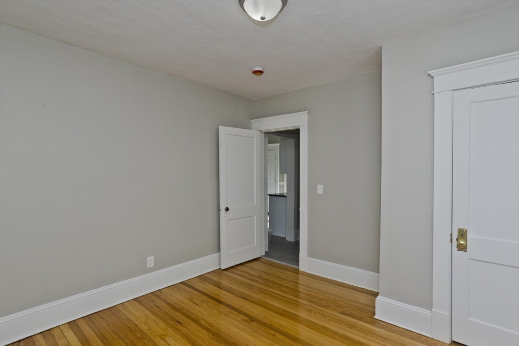 34-36 Ruskin Street Springfield, MA 01108 - Photo 19 of 27 a view of an empty room and wooden floor