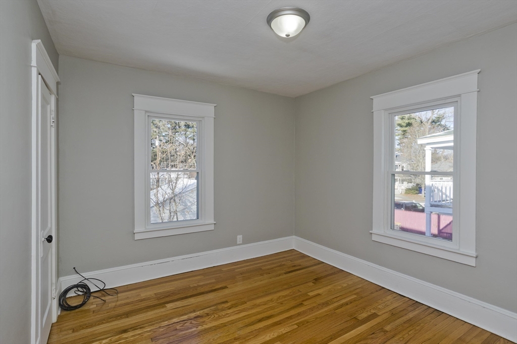 34-36 Ruskin Street Springfield, MA 01108 - Photo 20 of 27 a view of a room with wooden floor and windows