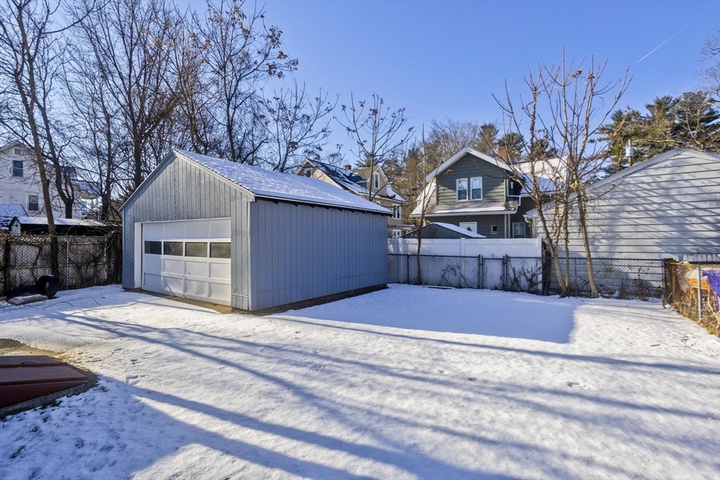 34-36 Ruskin Street Springfield, MA 01108 - Photo 24 of 27 a front view of a house with a yard and garage