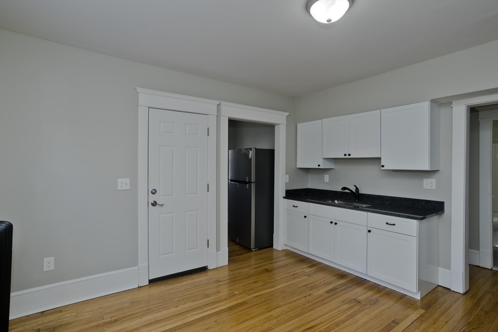 34-36 Ruskin Street Springfield, MA 01108 - Photo 6 of 27 a kitchen with granite countertop a stove and cabinets