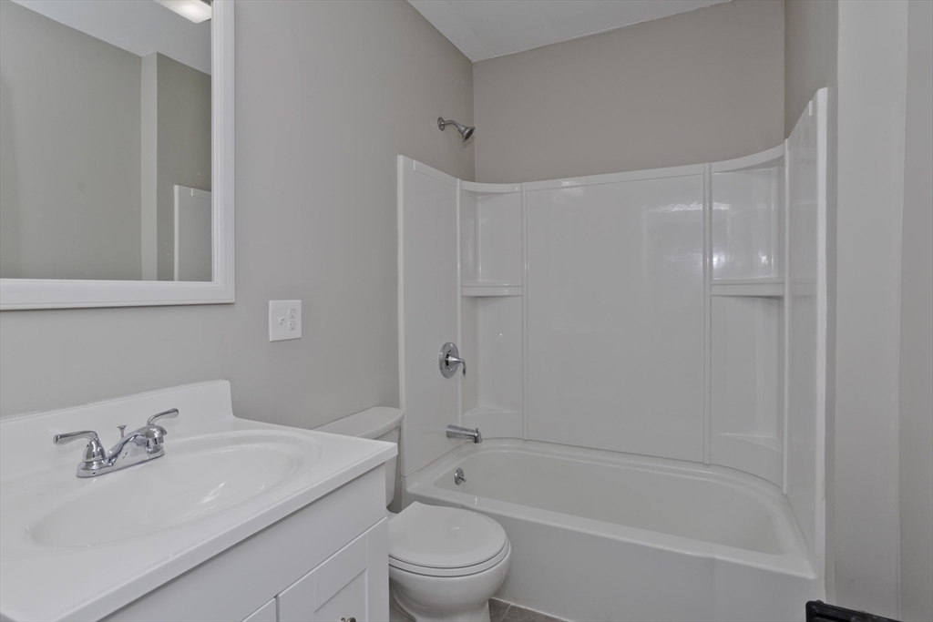 34-36 Ruskin Street Springfield, MA 01108 - Photo 8 of 27 a bathroom with a bathtub shower sink vanity and toilet