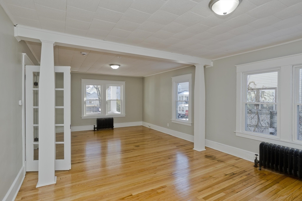 34-36 Ruskin Street Springfield, MA 01108 - Photo 10 of 27 a view of an empty room with window and wooden floor