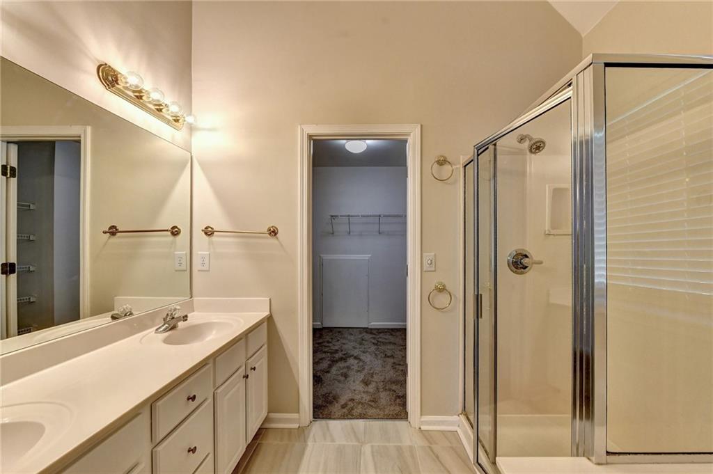 3460 Maple Terrace Drive Suwanee, GA 30024 - Photo 41 of 51 a bathroom with a shower sink and mirror