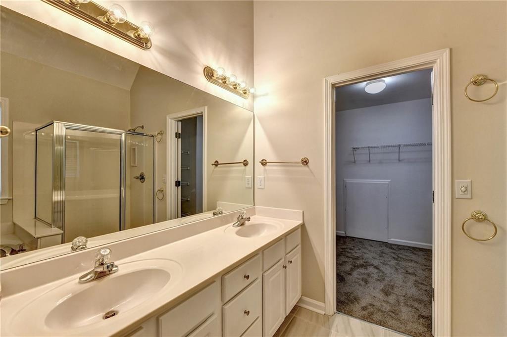 3460 Maple Terrace Drive Suwanee, GA 30024 - Photo 42 of 51 a bathroom with a sink and a mirror
