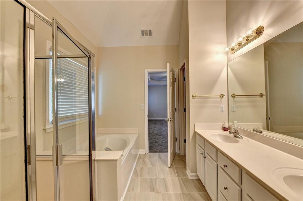 3460 Maple Terrace Drive Suwanee, GA 30024 - Photo 43 of 51 a bathroom with a double vanity sink and a mirror