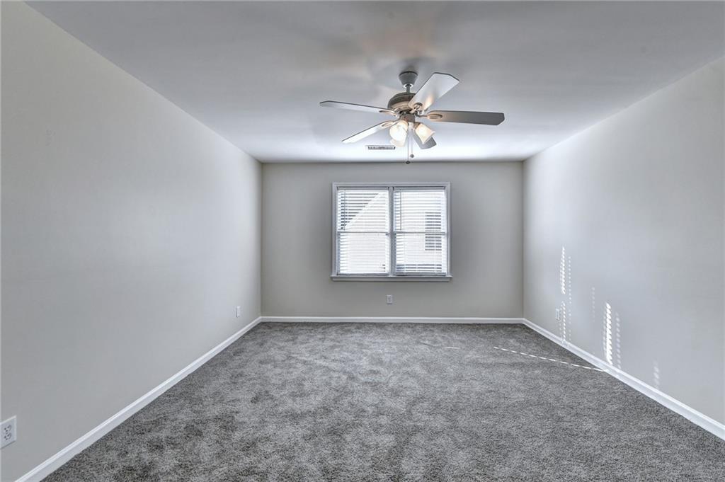 3460 Maple Terrace Drive Suwanee, GA 30024 - Photo 45 of 51 a view of room with a ceiling fan and window