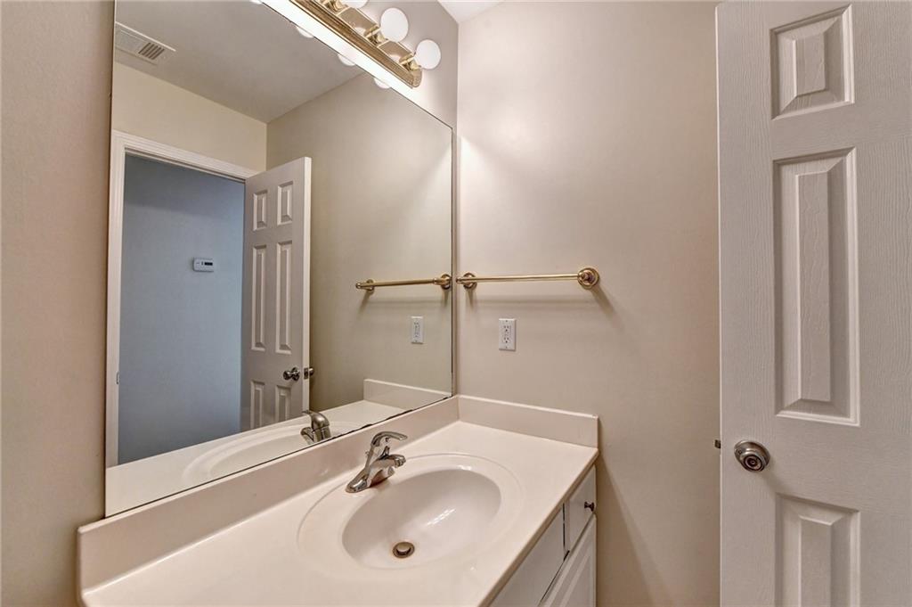 3460 Maple Terrace Drive Suwanee, GA 30024 - Photo 48 of 51 a bathroom with a sink and a mirror
