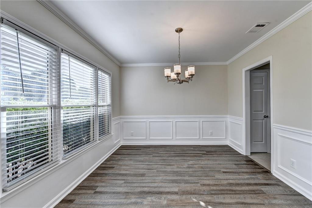 3460 Maple Terrace Drive Suwanee, GA 30024 - Photo 8 of 51 a view of empty room with wooden floor and fan