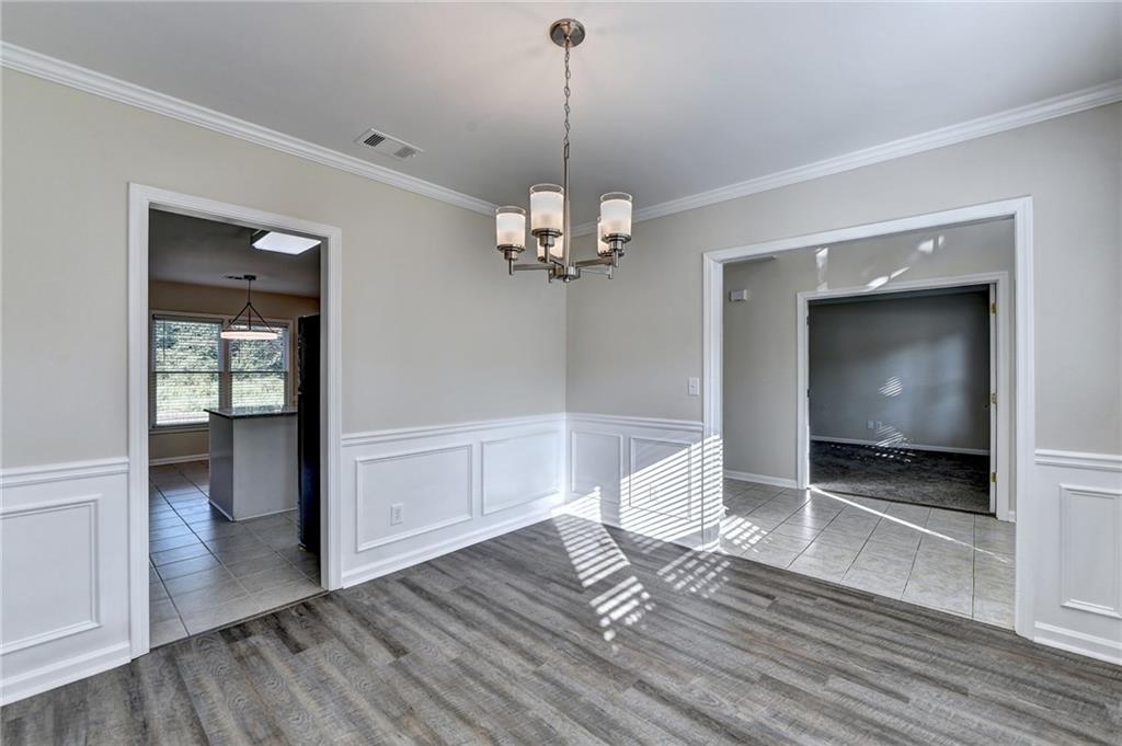 3460 Maple Terrace Drive Suwanee, GA 30024 - Photo 10 of 51 a view of a room with wooden floor staircase and a living room