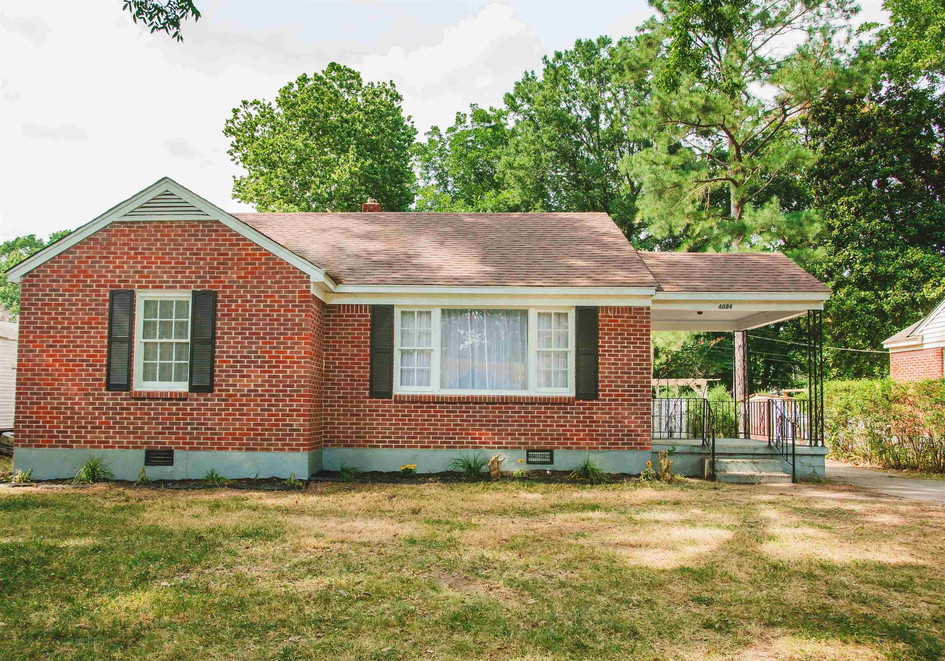 4094 Lawrence Road Memphis, TN 38122 - Photo 1 of 24 a front view of a house with garden