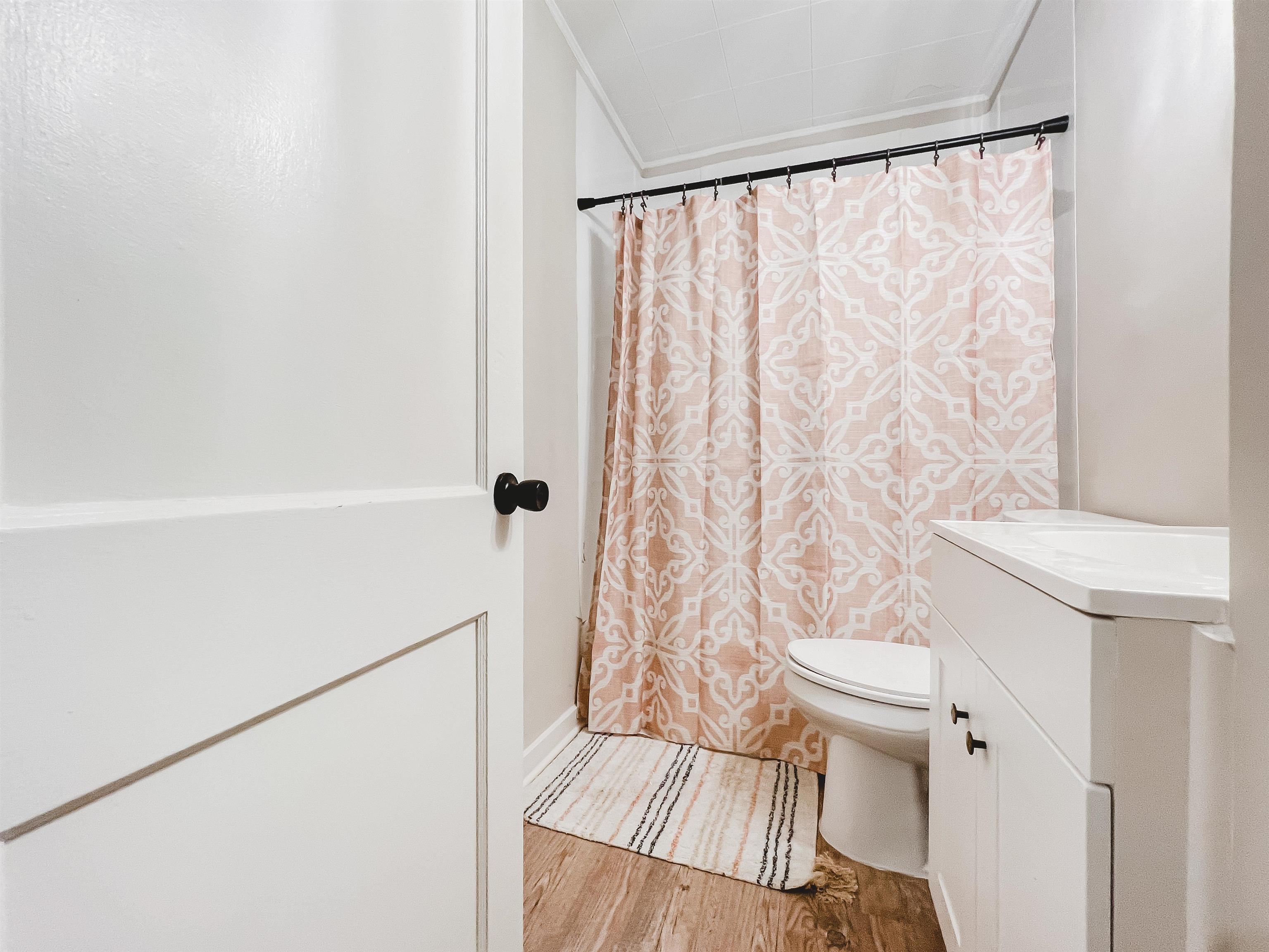 4094 Lawrence Road Memphis, TN 38122 - Photo 16 of 24 a white toilet sitting next to a shower curtain