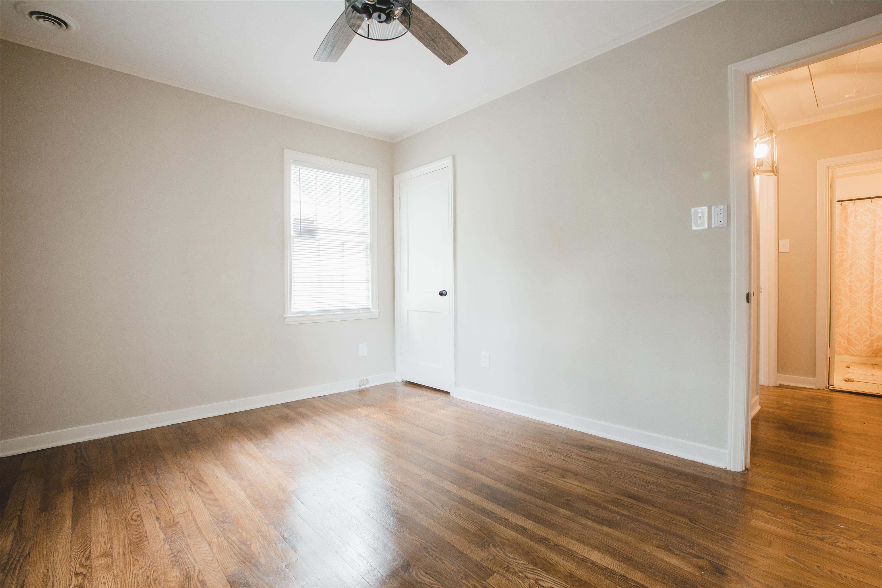 4094 Lawrence Road Memphis, TN 38122 - Photo 18 of 24 an empty room with wooden floor and windows
