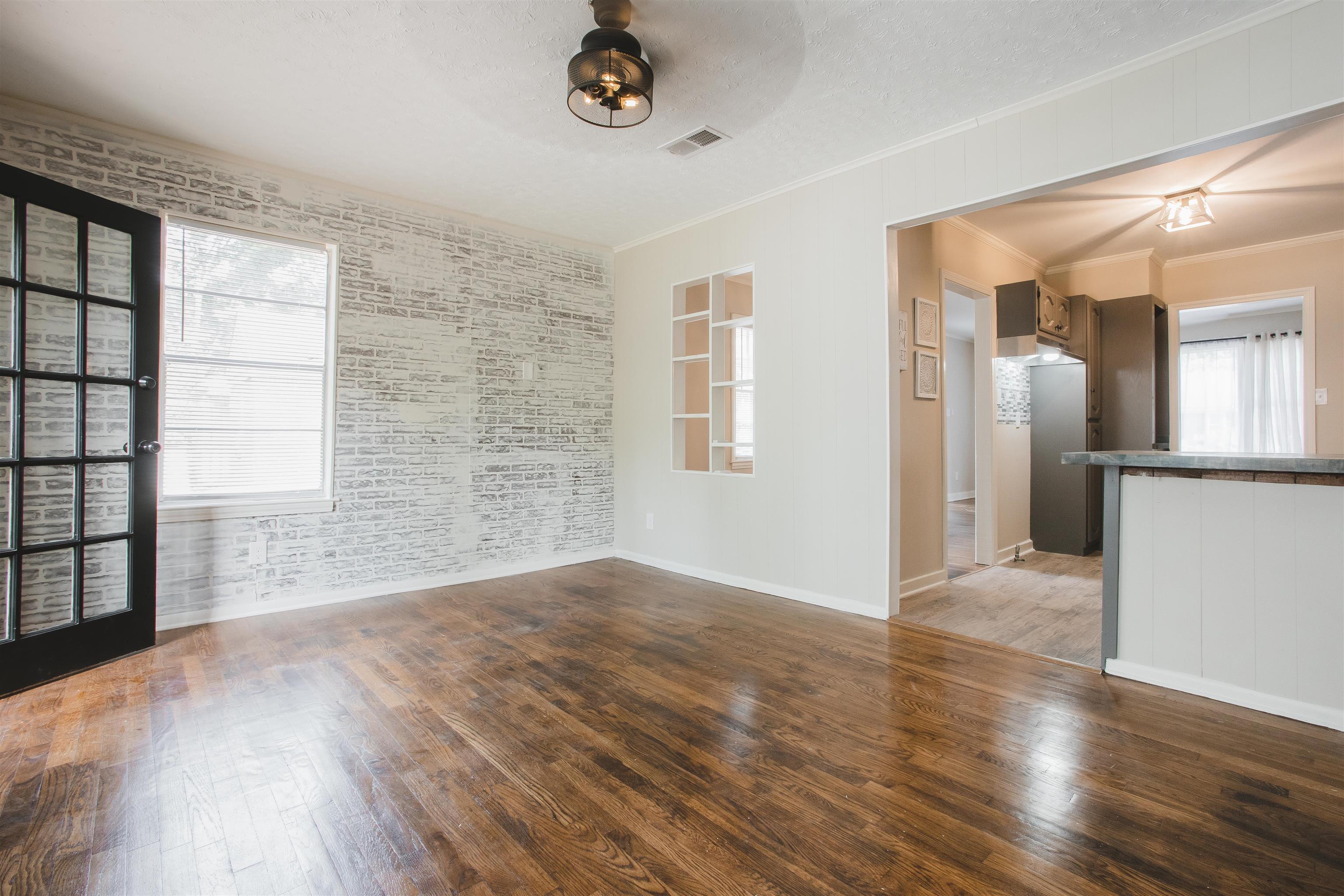4094 Lawrence Road Memphis, TN 38122 - Photo 20 of 24 an empty room with wooden floor and windows