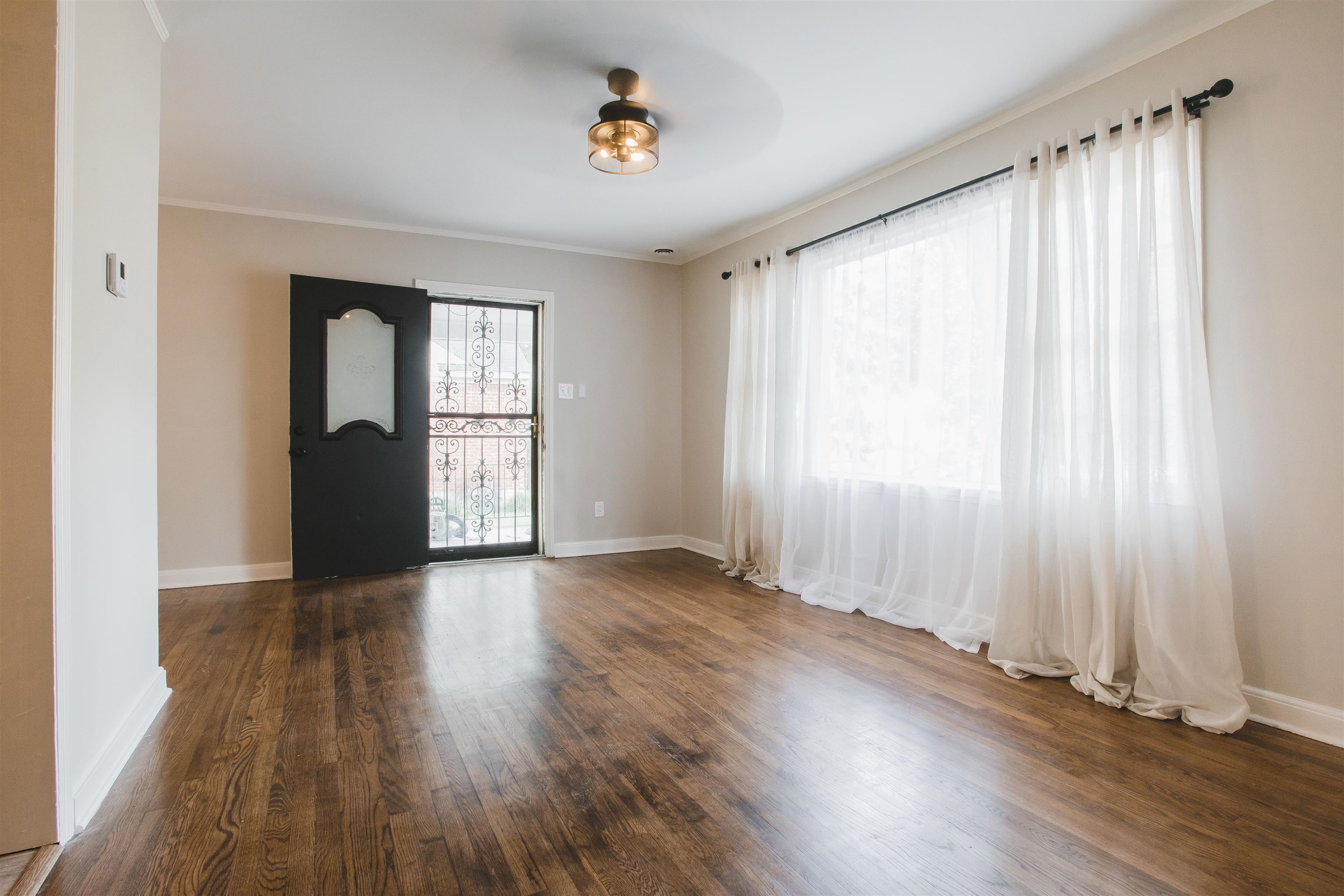 4094 Lawrence Road Memphis, TN 38122 - Photo 2 of 24 an empty room with wooden floor and windows