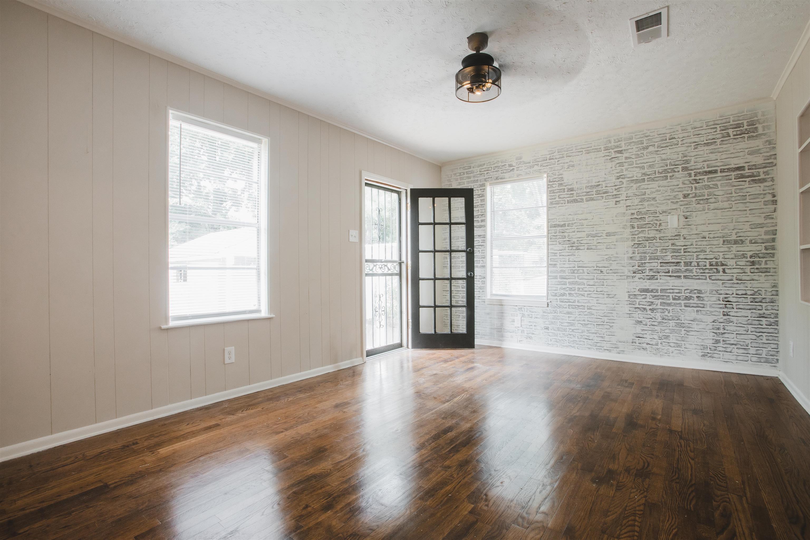 4094 Lawrence Road Memphis, TN 38122 - Photo 21 of 24 a view of an empty room with a window and wooden floor