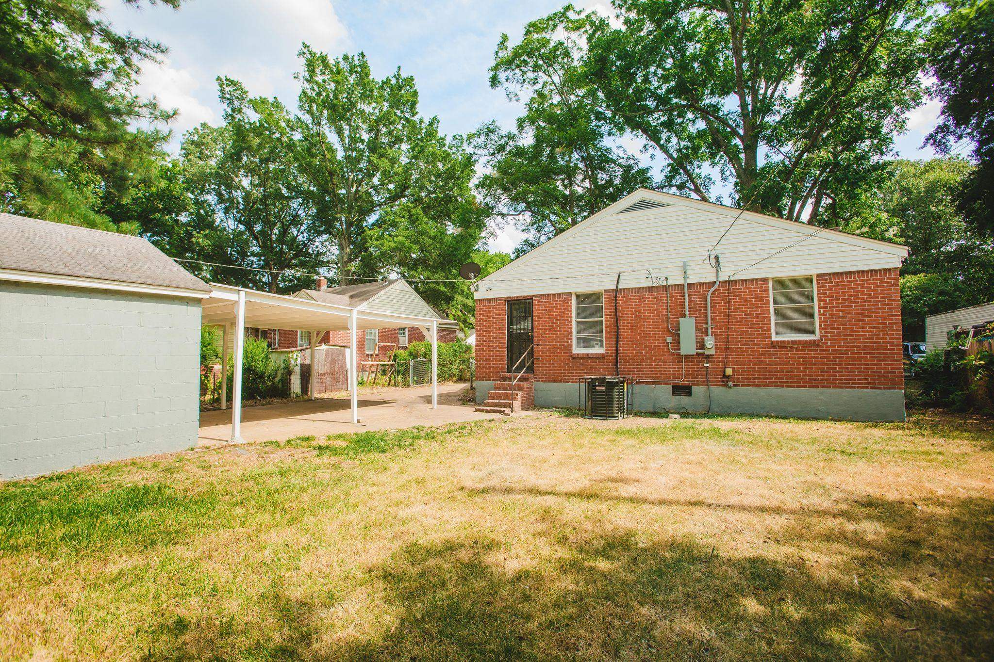 4094 Lawrence Road Memphis, TN 38122 - Photo 24 of 24 a backyard of a house with yard and outdoor seating