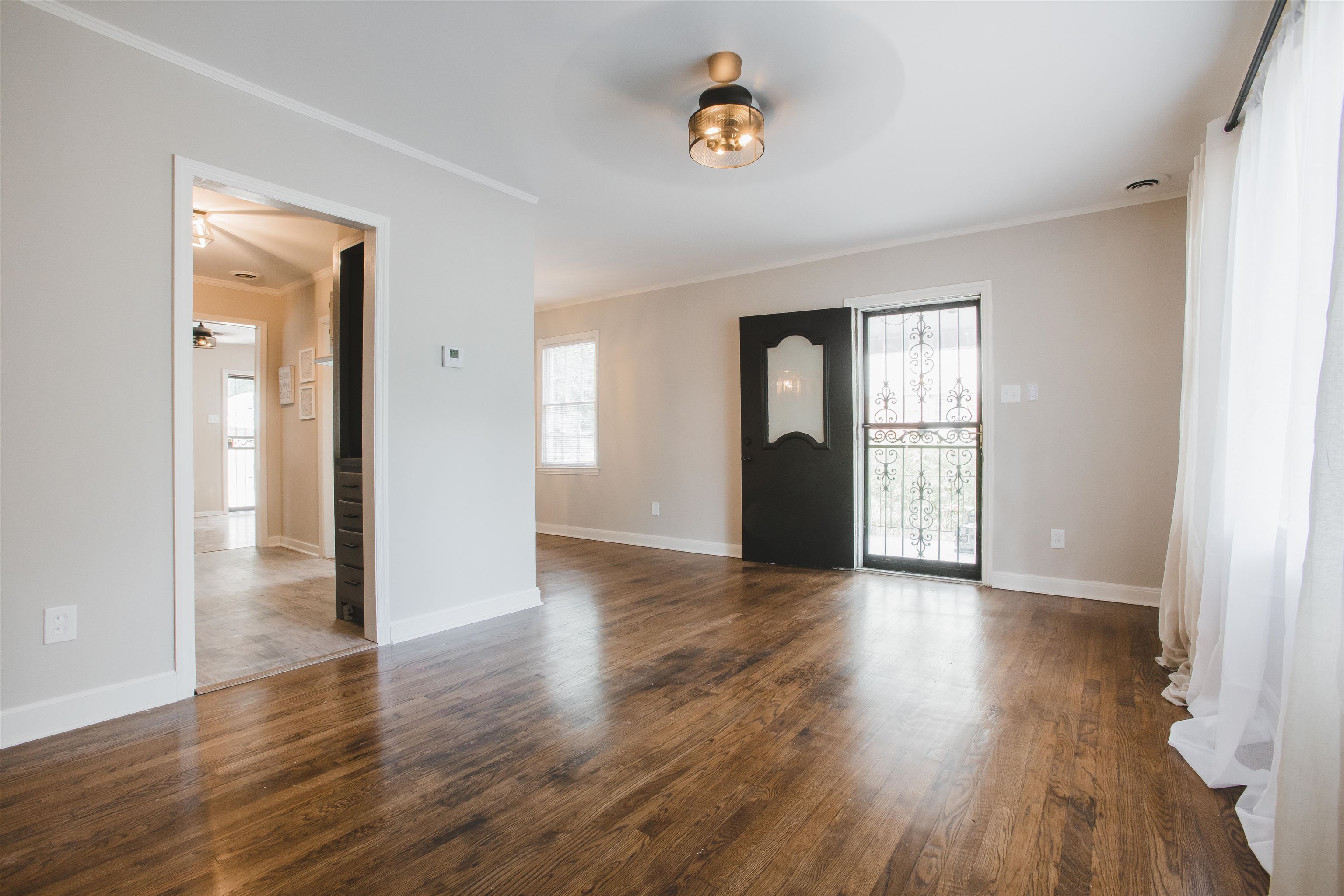 4094 Lawrence Road Memphis, TN 38122 - Photo 3 of 24 an empty room with wooden floor and windows