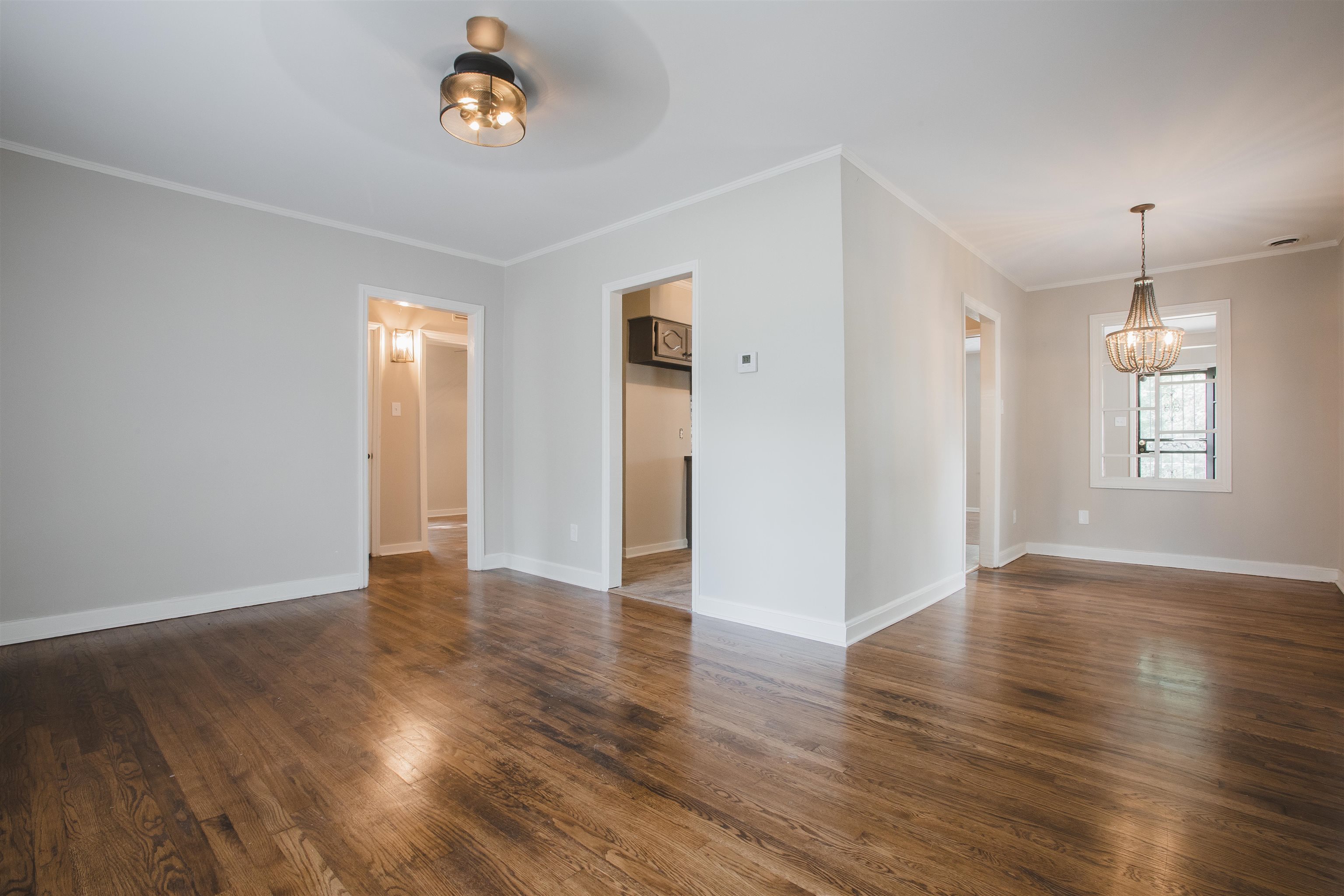 4094 Lawrence Road Memphis, TN 38122 - Photo 4 of 24 an empty room with wooden floor and windows
