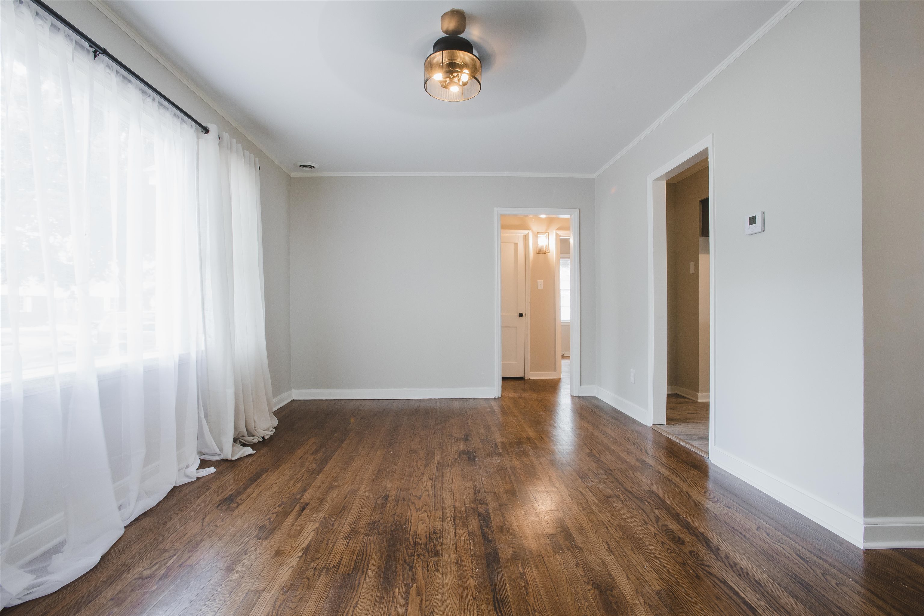 4094 Lawrence Road Memphis, TN 38122 - Photo 6 of 24 an empty room with wooden floor and a window