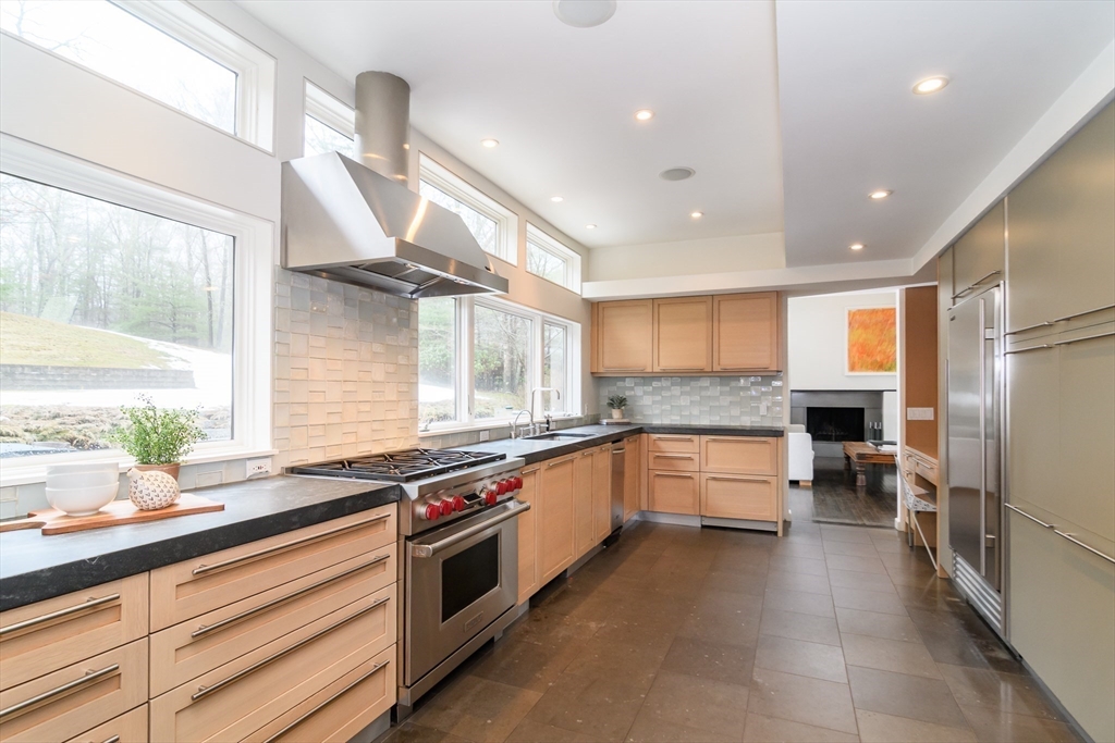 41 Grove Street Wayland, MA 01778 - Photo 6 of 24 a kitchen with stainless steel appliances granite countertop a sink and stove