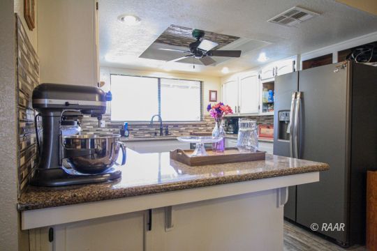 1124 Faith Court Ridgecrest, CA 93555 - Photo 9 of 35 a kitchen with counter top space cabinets and stainless steel appliances