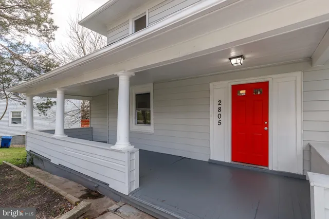 a view of a house with a small backyard