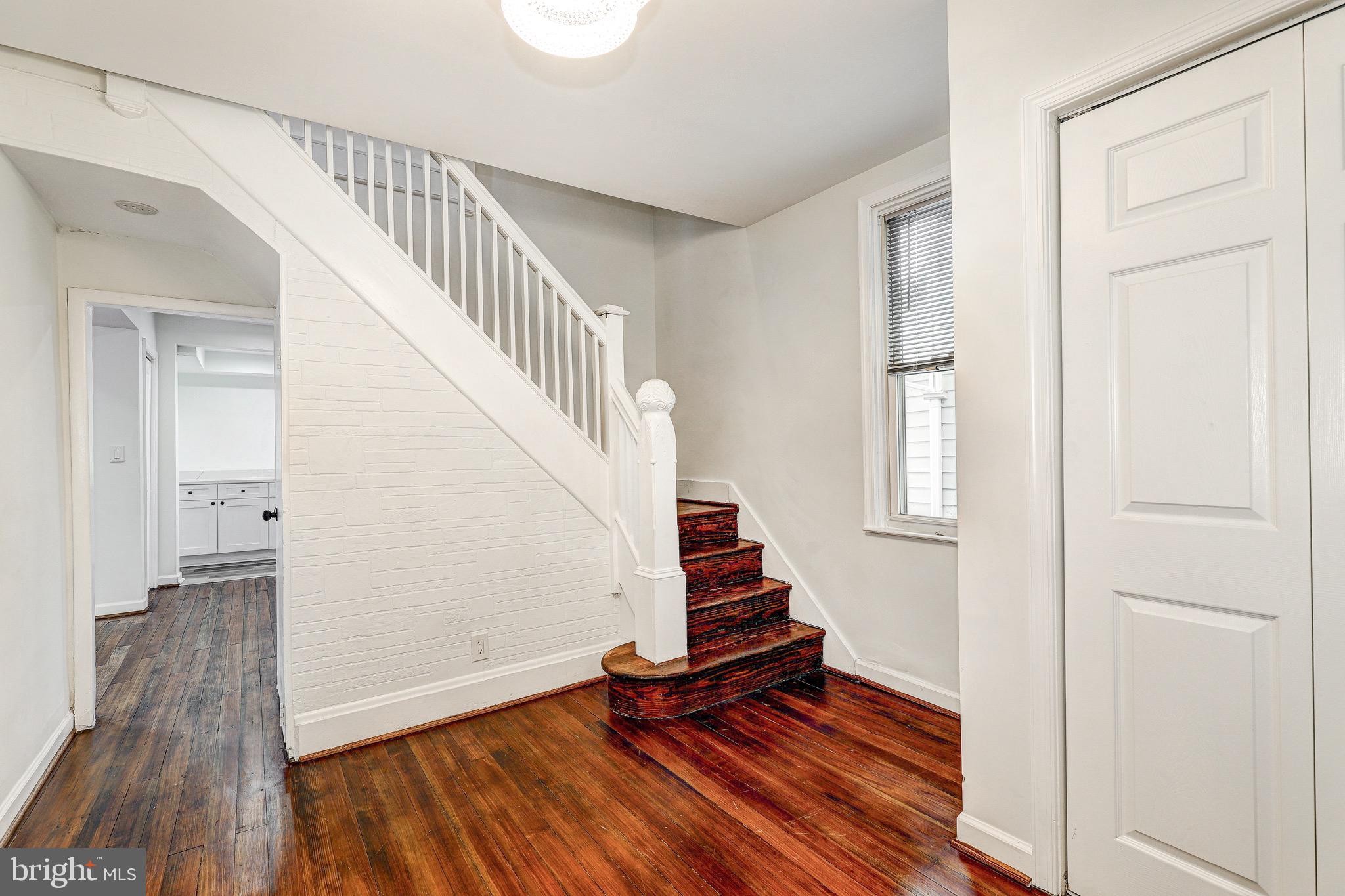 2805 Hamilton Avenue Baltimore, MD 21214 - Photo 15 of 41 a view of entryway with wooden floor and stairs