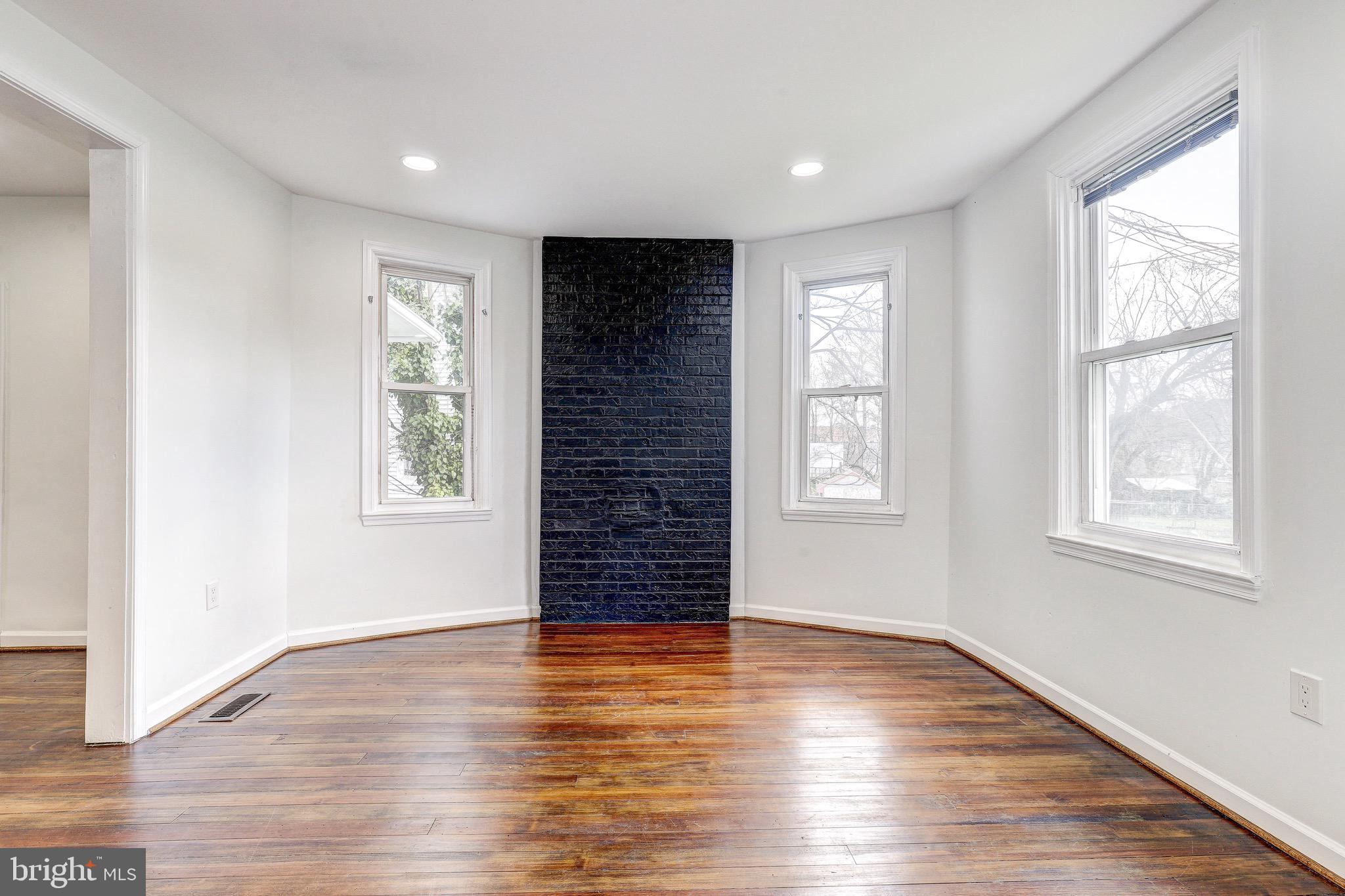2805 Hamilton Avenue Baltimore, MD 21214 - Photo 17 of 41 an empty room with wooden floor and windows