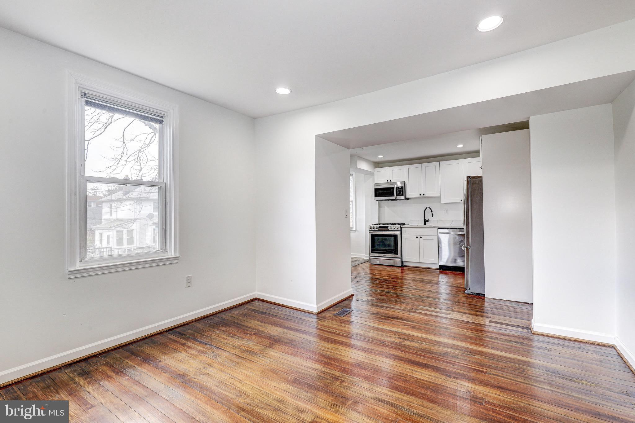 2805 Hamilton Avenue Baltimore, MD 21214 - Photo 18 of 41 an empty room with wooden floor and windows