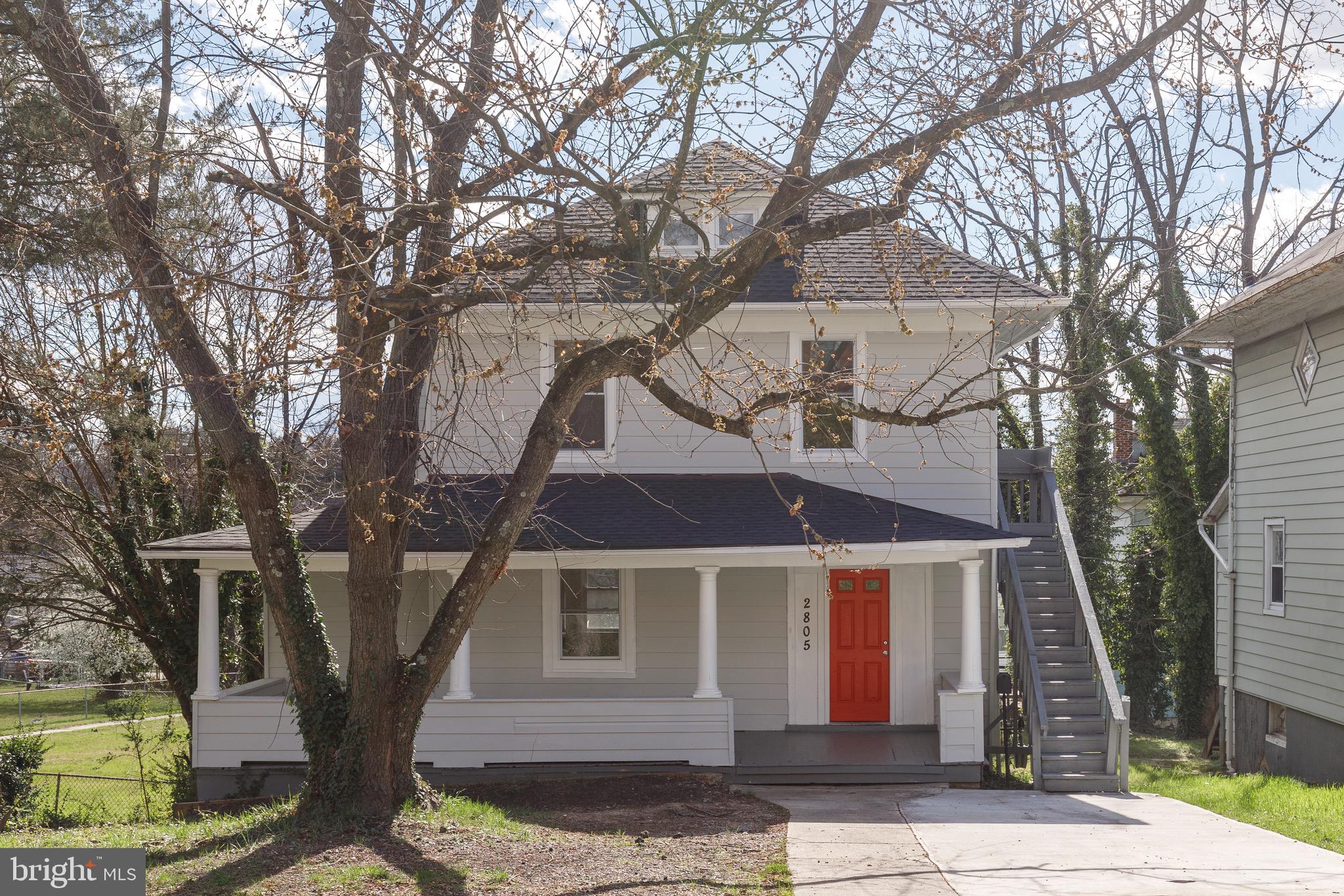 2805 Hamilton Avenue Baltimore, MD 21214 - Photo 2 of 41 a front view of a house with a tree