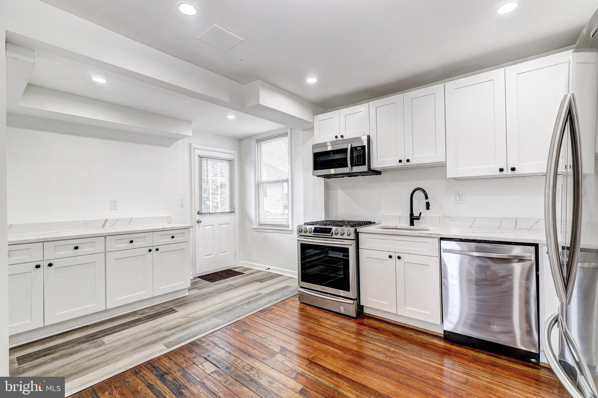 2805 Hamilton Avenue Baltimore, MD 21214 - Photo 22 of 41 a kitchen with white cabinets and appliances