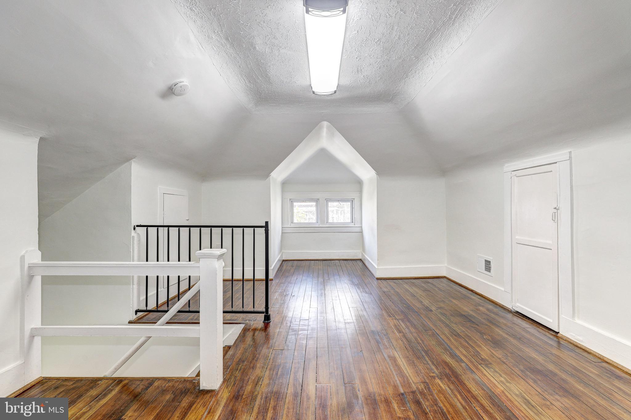 2805 Hamilton Avenue Baltimore, MD 21214 - Photo 25 of 41 a view of empty room with wooden floor and fan