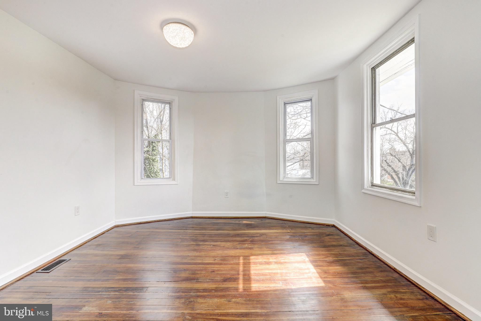 2805 Hamilton Avenue Baltimore, MD 21214 - Photo 31 of 41 an empty room with wooden floor and windows