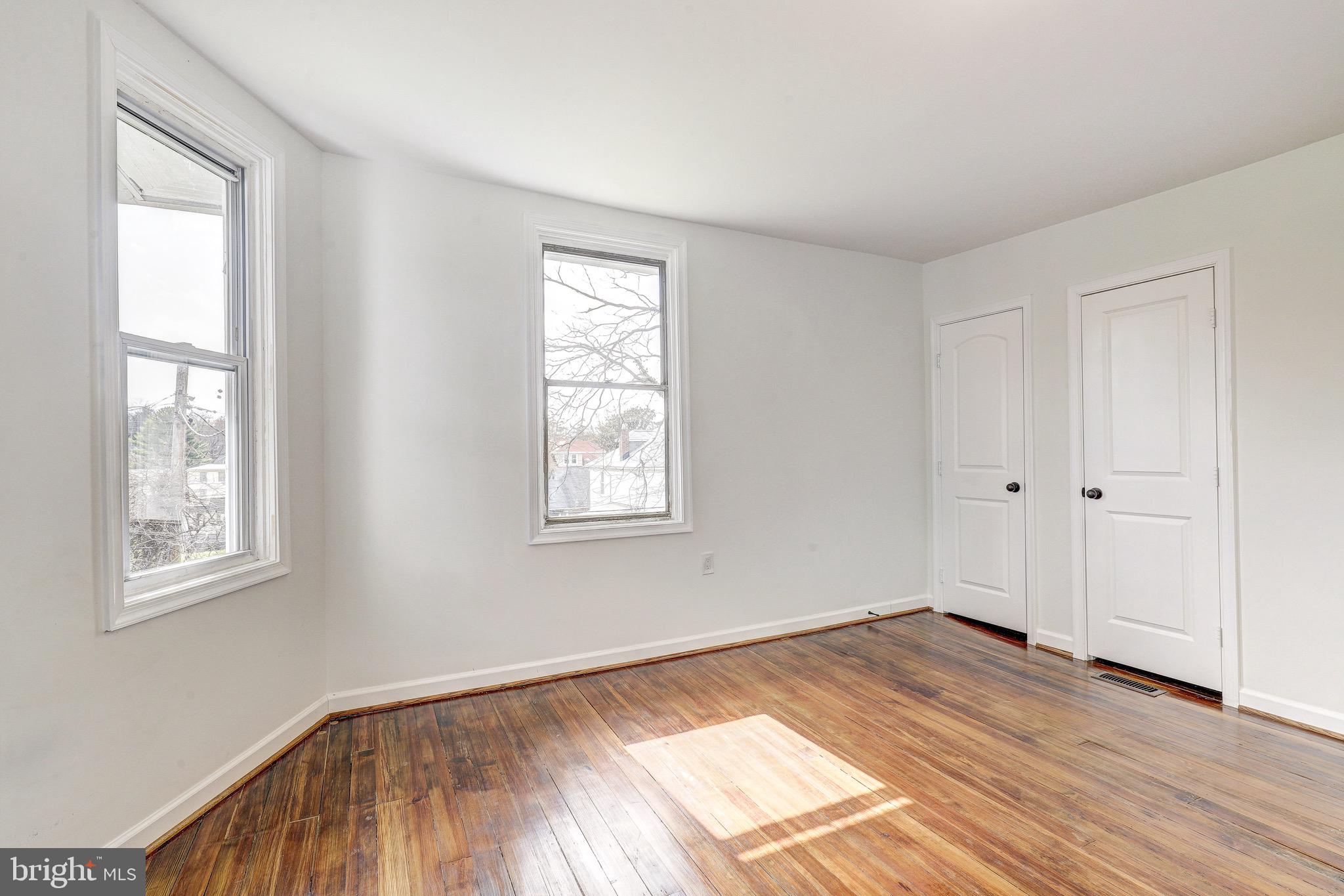 2805 Hamilton Avenue Baltimore, MD 21214 - Photo 32 of 41 a view of empty room with wooden floor and fan