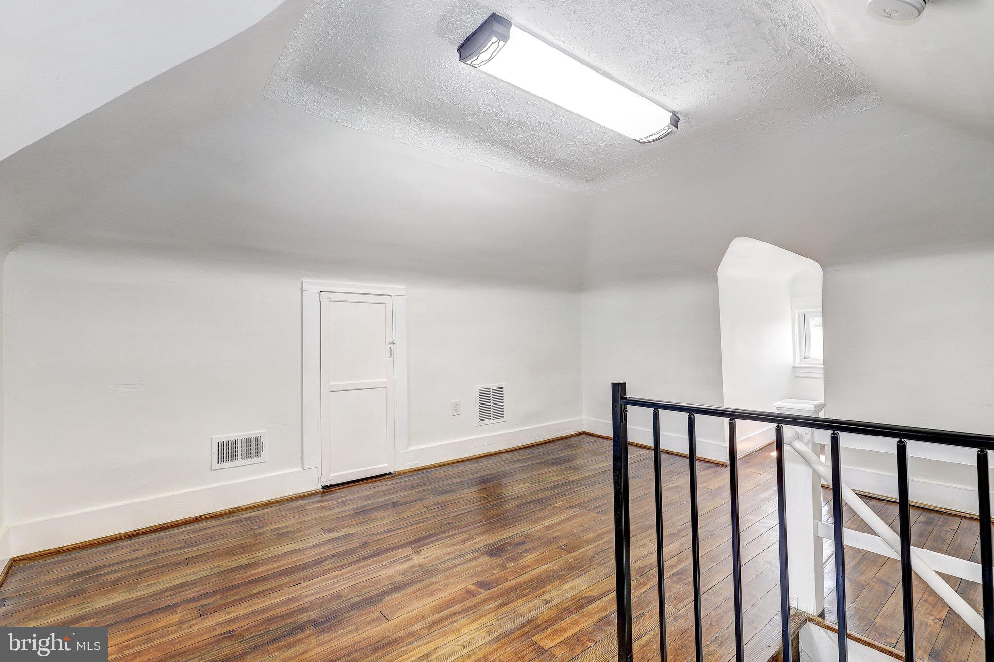 2805 Hamilton Avenue Baltimore, MD 21214 - Photo 38 of 41 a view of a hallway with wooden floor