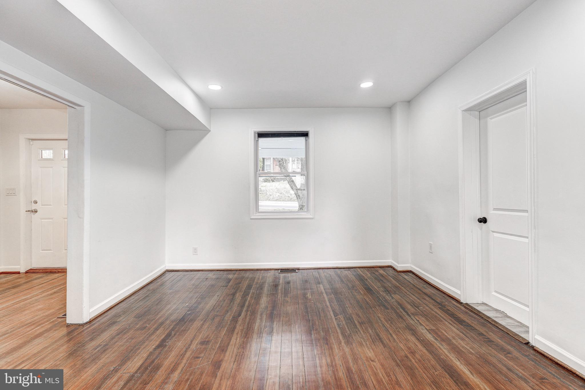 2805 Hamilton Avenue Baltimore, MD 21214 - Photo 40 of 41 wooden floor in an empty room with a window