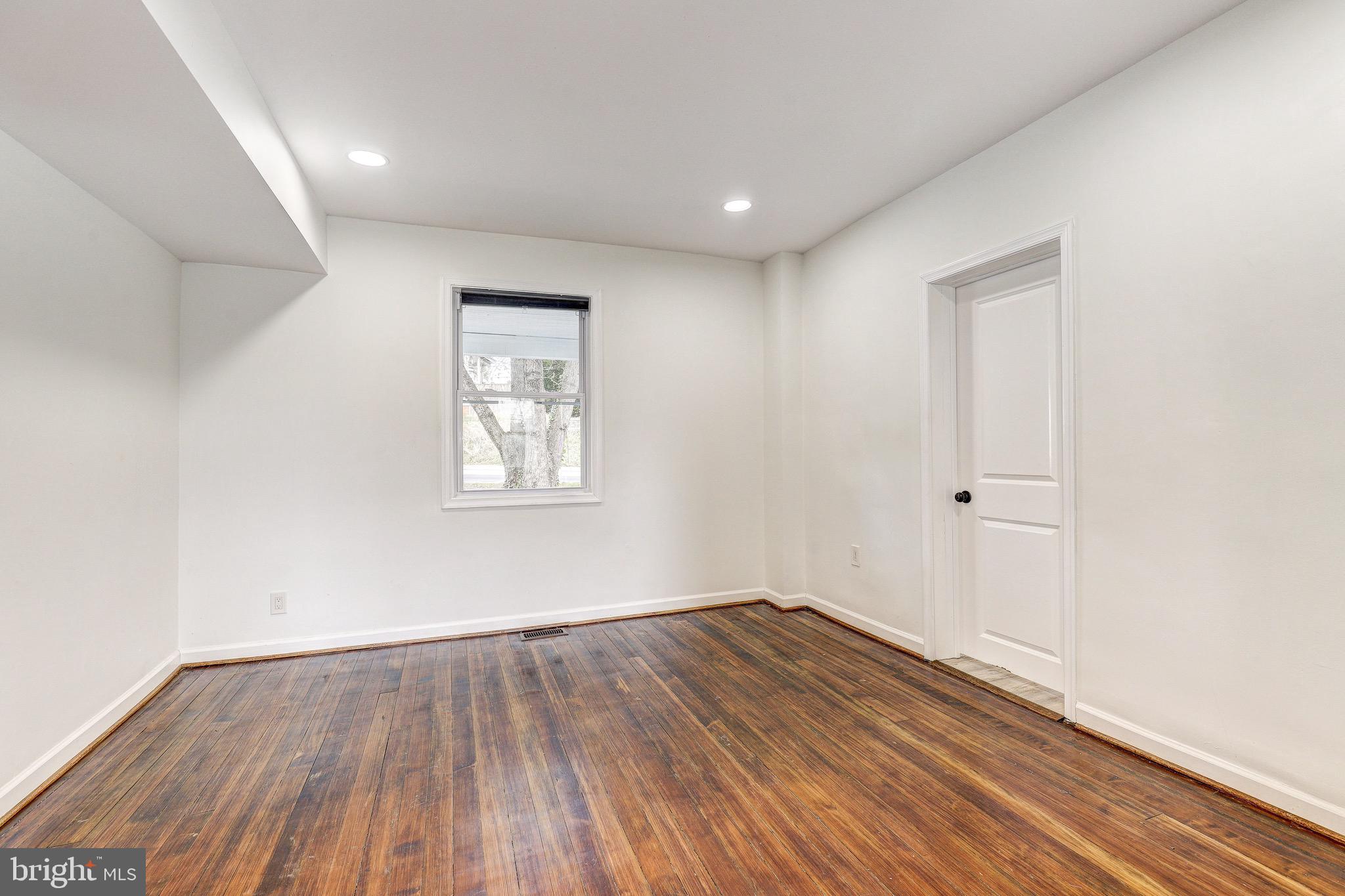 2805 Hamilton Avenue Baltimore, MD 21214 - Photo 41 of 41 an empty room with wooden floor and windows